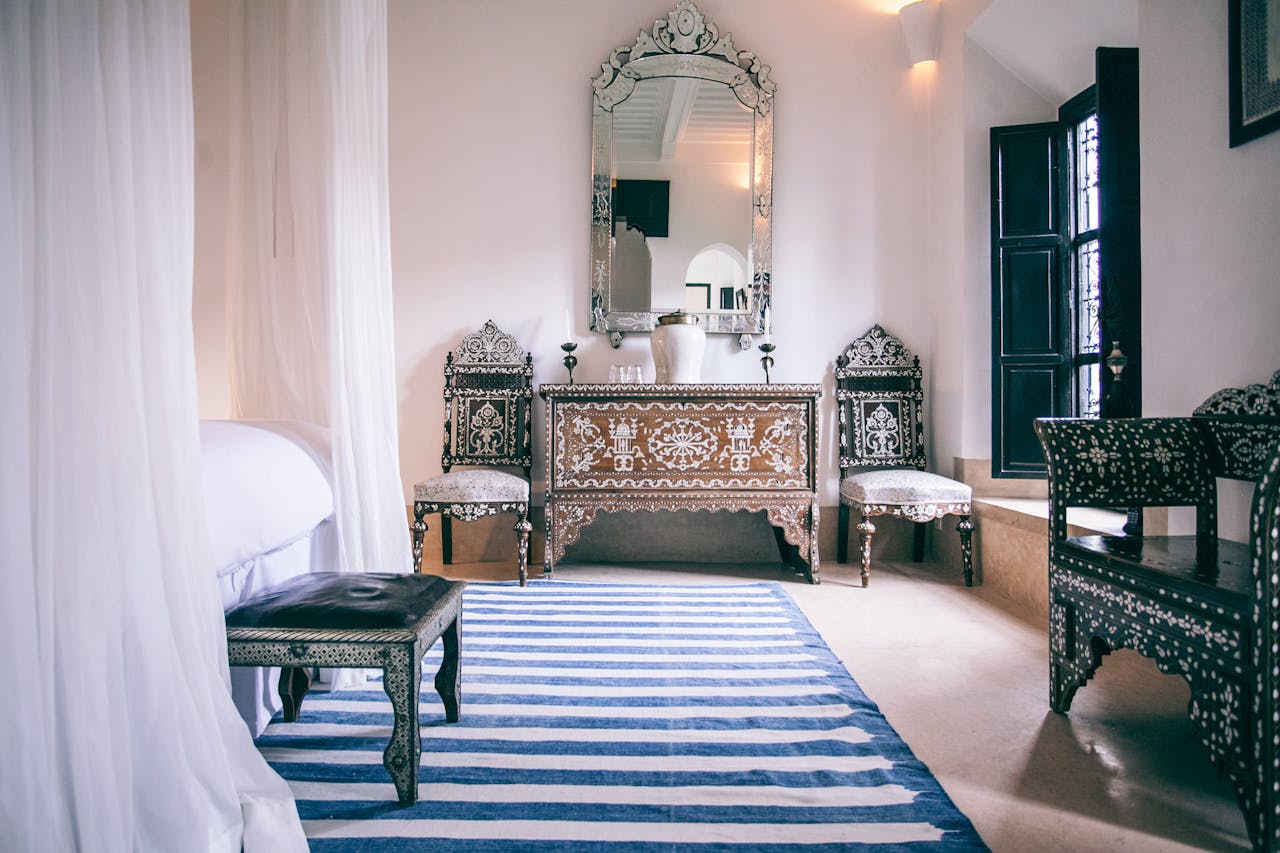 Stylish Moroccan bedroom featuring intricate wooden furniture and bright natural light.